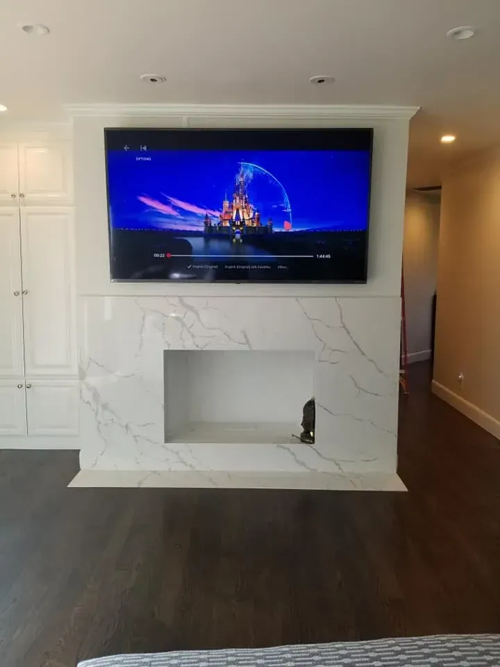 Small kitchen upgrade with white cabinetry, granite countertops, black appliances, and tile backsplash