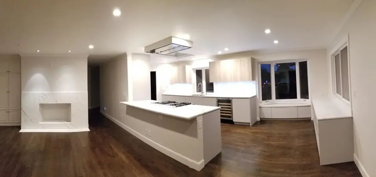 Bright kitchen remodel featuring white shaker cabinets, apron-front farmhouse sink, and marble countertops