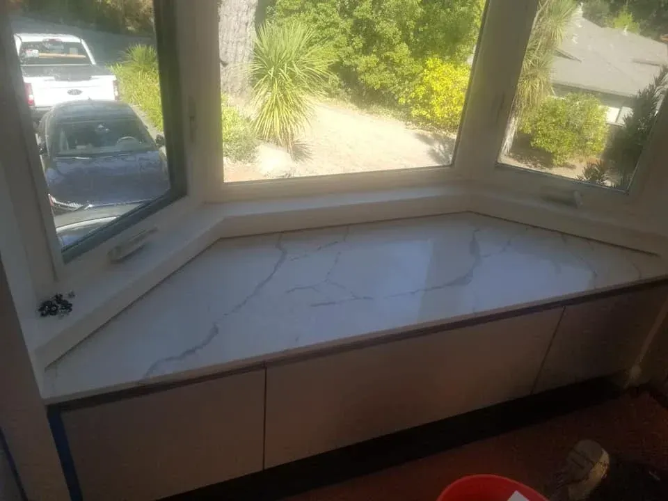 Custom bathroom renovation with tiled walk-in shower and rustic wood vanity with black sink