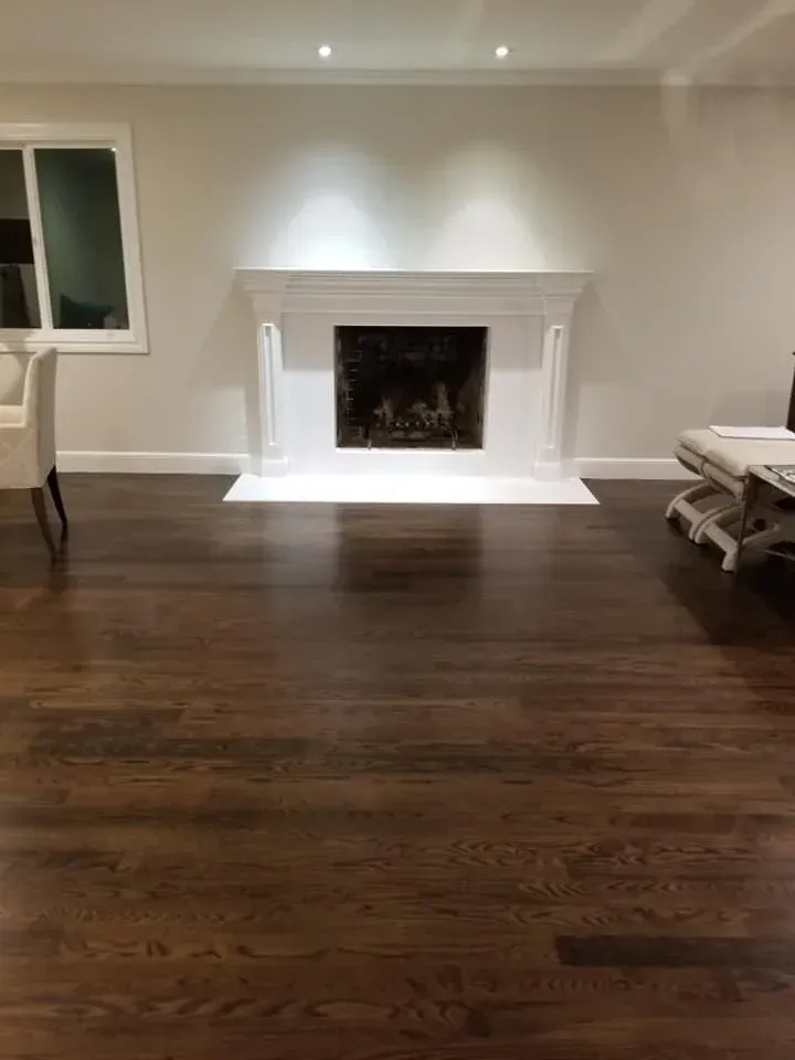 Spacious open-concept kitchen renovation with white cabinetry, island seating, and warm lighting