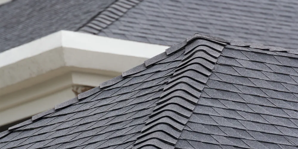 Asphalt shingle roof installation on residential home with clean lines and ridge vent