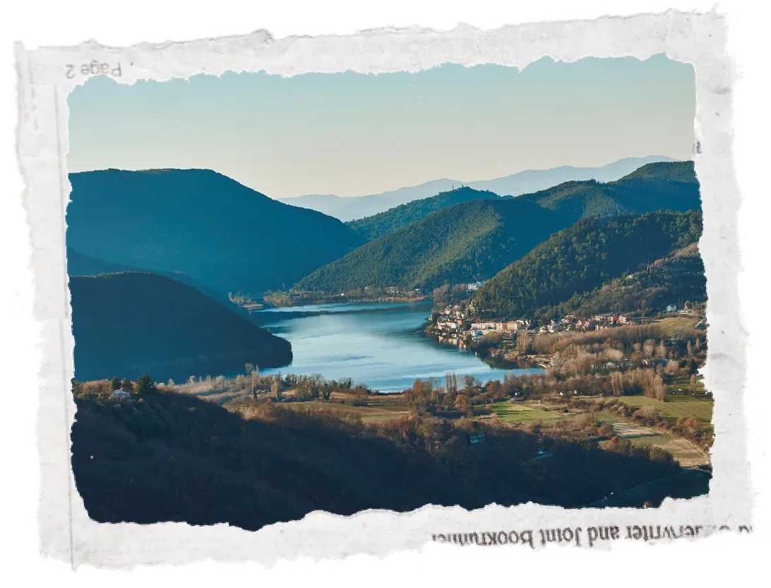 Scenic view of a lake nestled between green mountains
