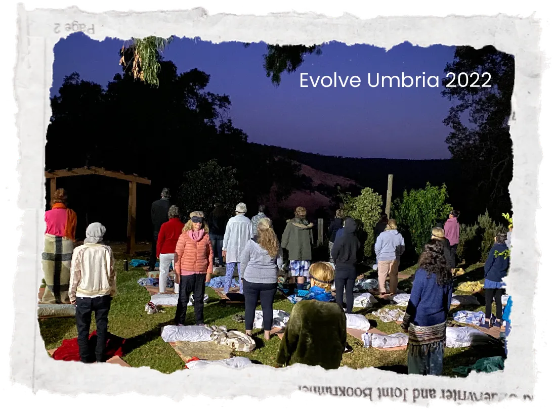 Large group of people gathered outdoors on a patio with a dark sky, lit by event lights, photo with torn paper edges