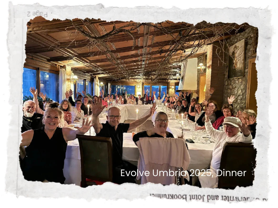 Group of people dining at a long table outdoors under a patio roof, photo has torn paper edges
