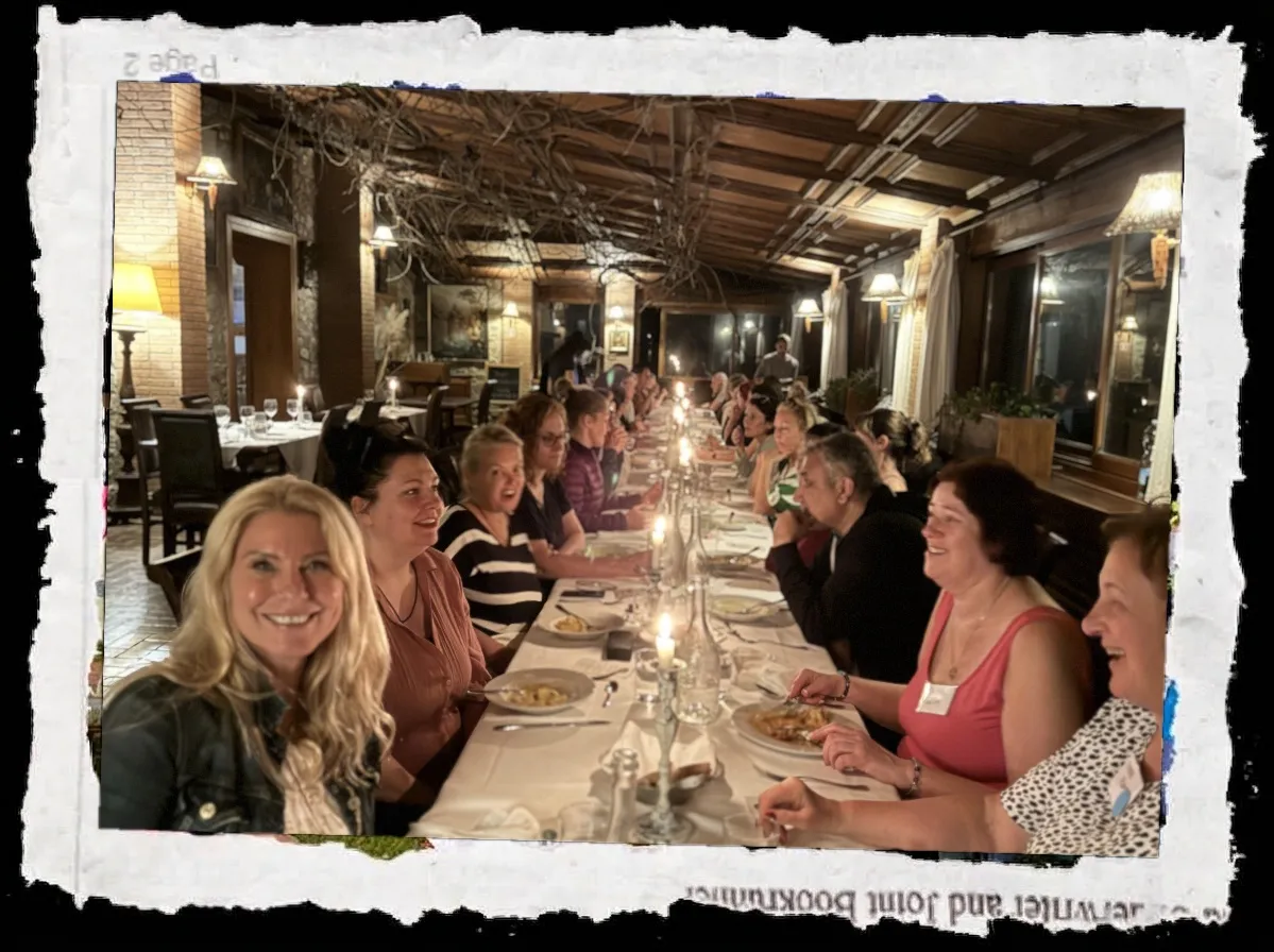 Group dining at a long table outdoors under string lights, photo with torn paper edges