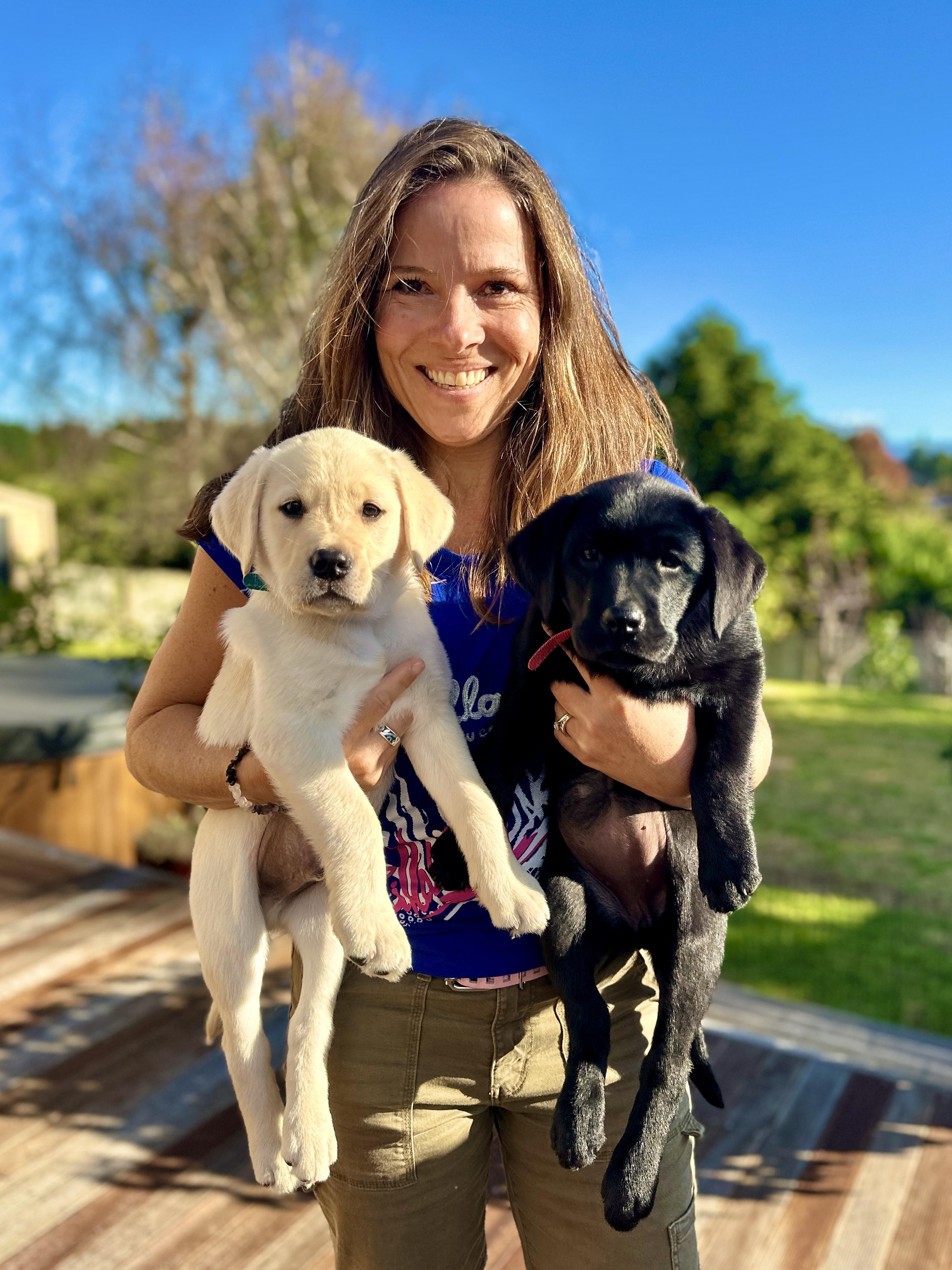 Guide smiling with their dog, both relaxed.