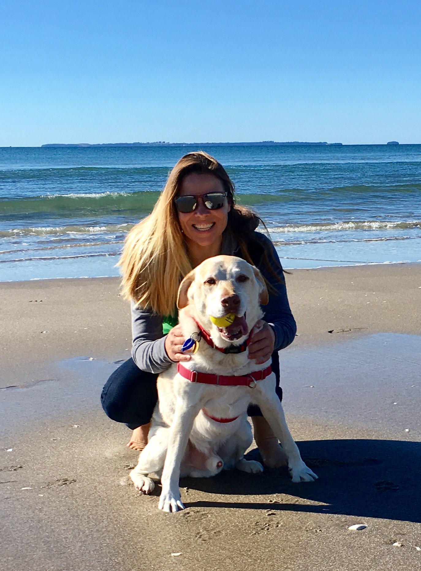 Jules with her Labrador Benjamin holding a ball