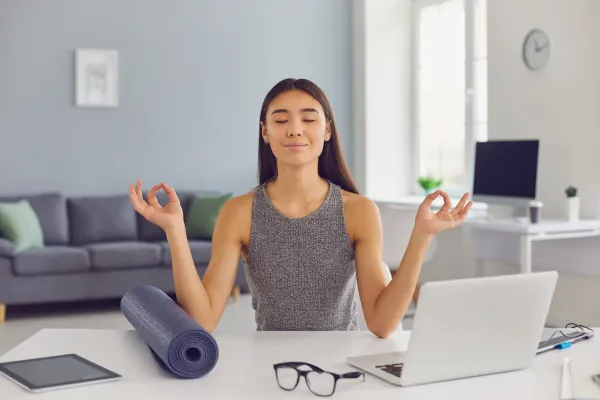 A professional adult working calmly at a desk, practicing proper nasal breathing and tongue posture to improve concentration.