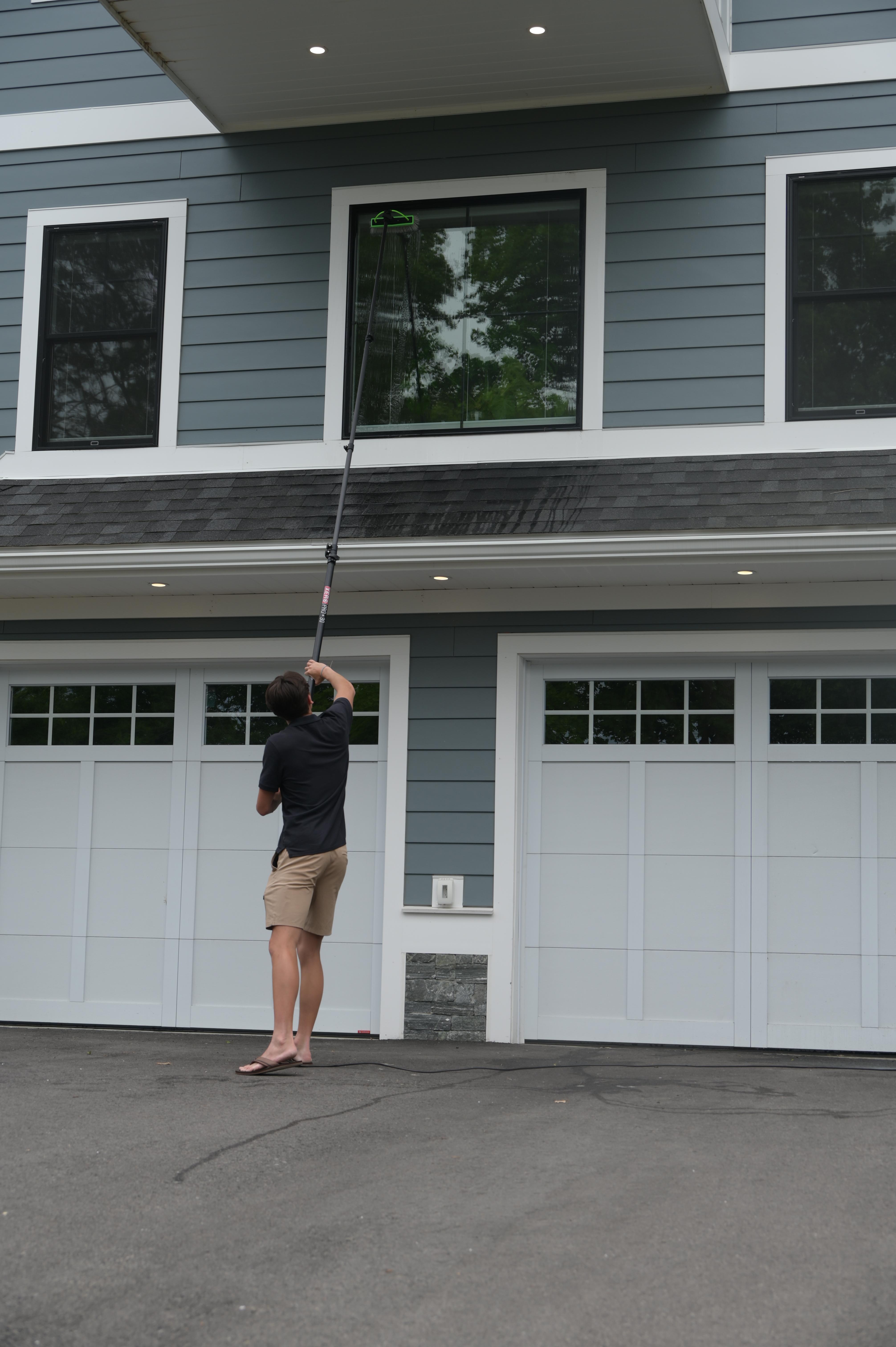 Technician using professional tools to clean interior glass