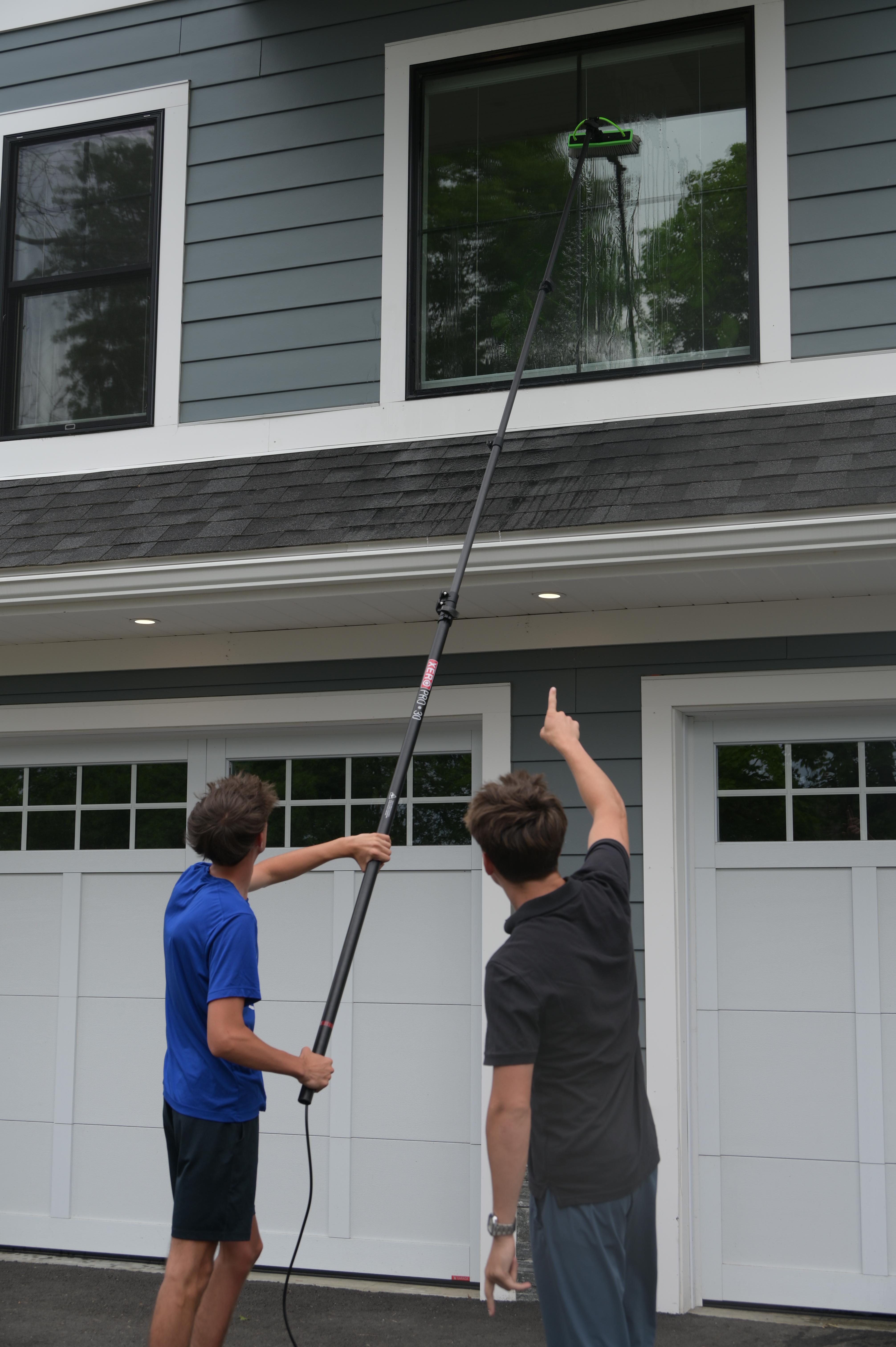 ClearView team cleaning large home windows from the exterior