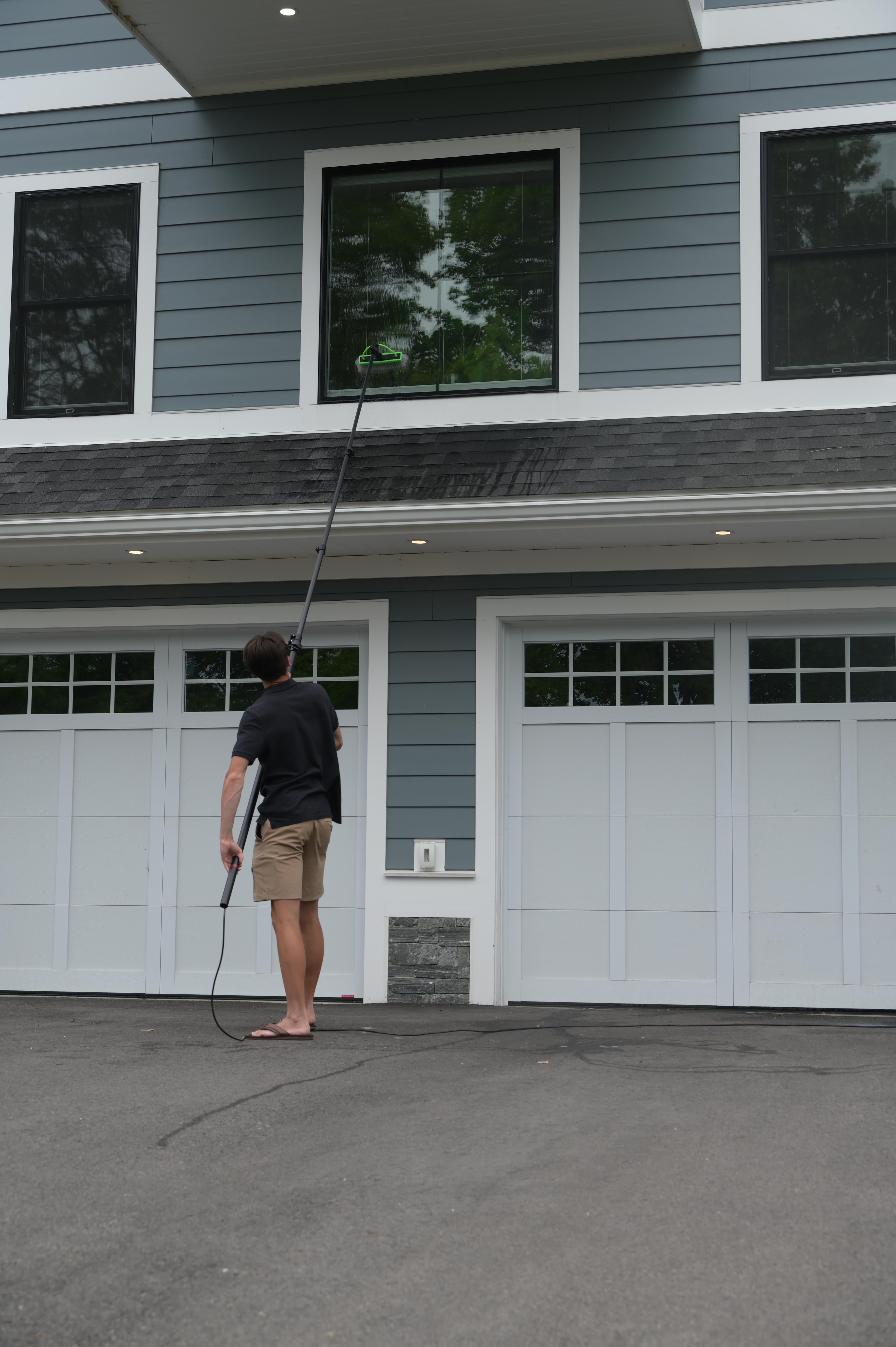ClearView team cleaning large home windows from the exterior