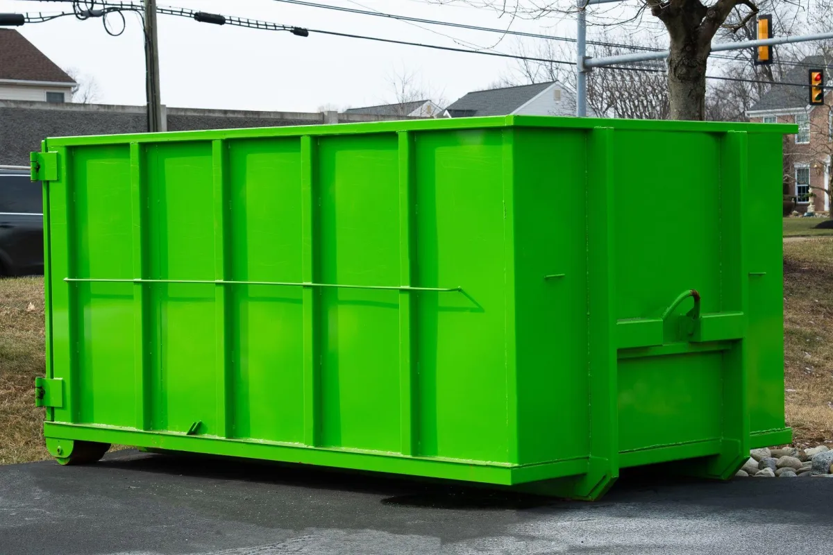 Bright green dumpster after final inspection and cleaning