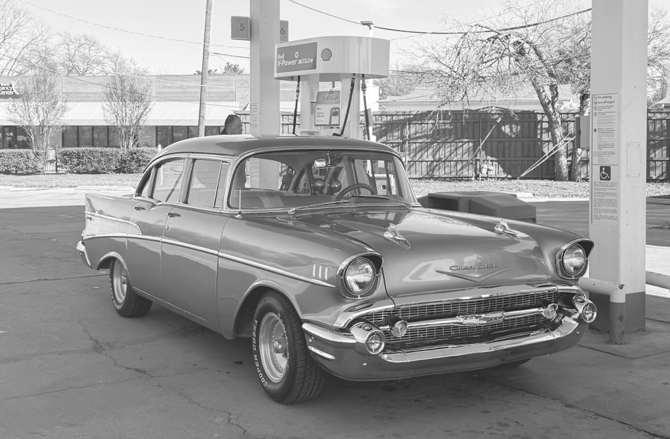 A black luxury sedan parked on the roadside.
