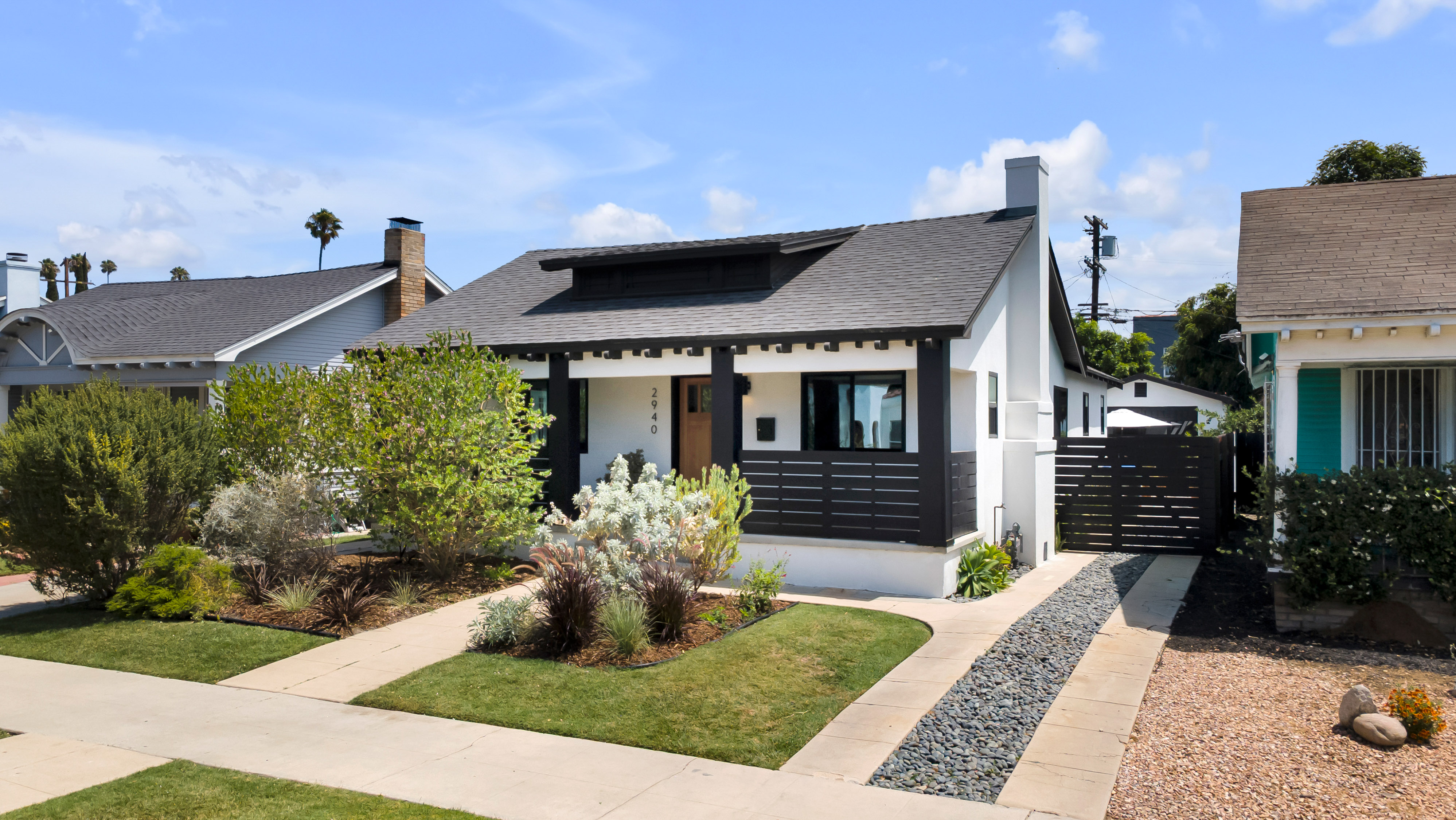 The front view of a recently sold home in Brea, California. It's a stucco home with a recessed entryway and lovely landscaping.