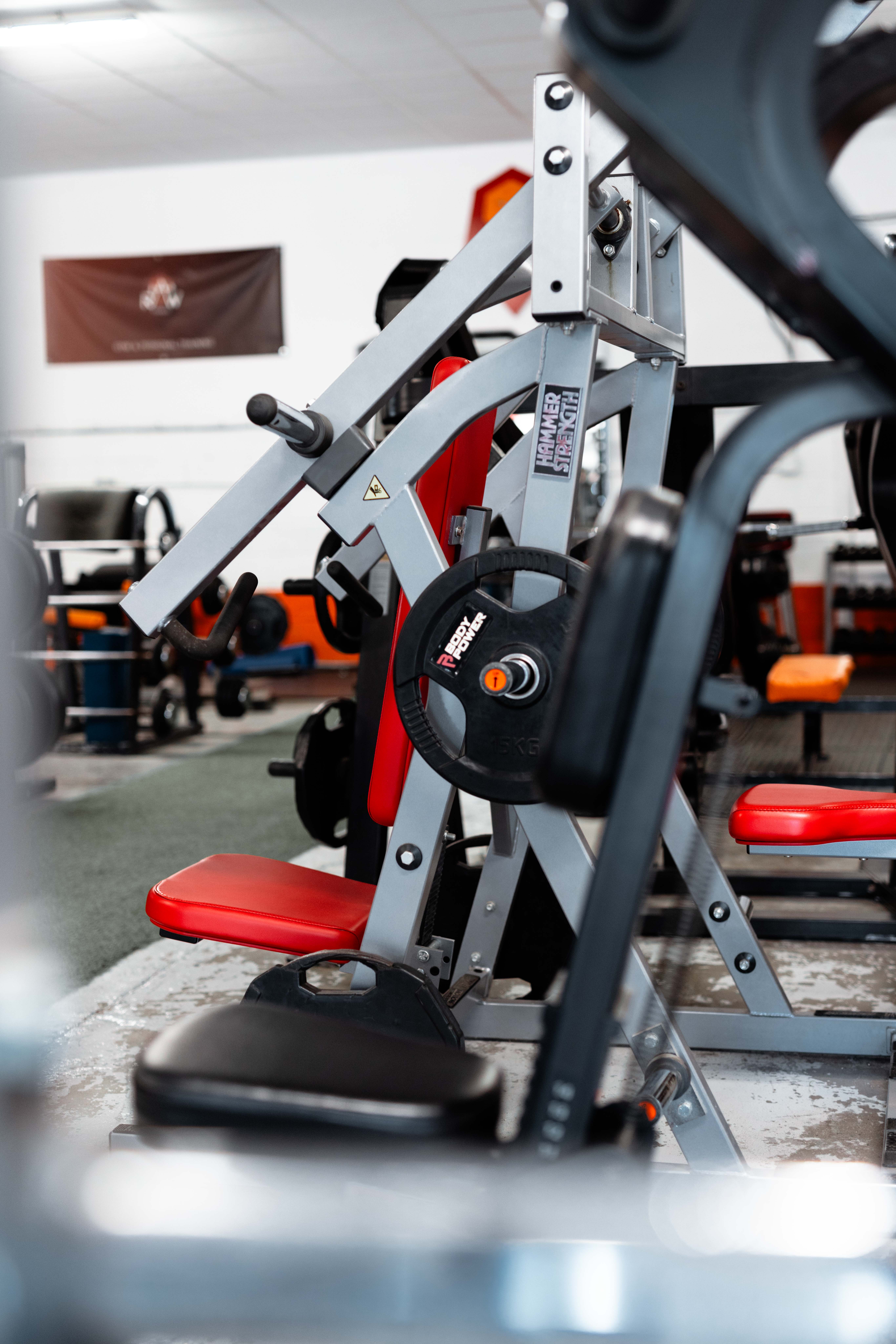 Spacious free weights area with natural light and modern decor
