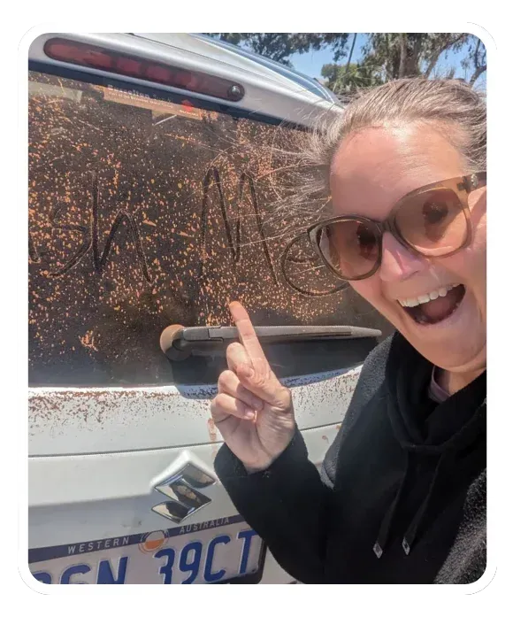 Photo of Ellie Clare, excited about how dirty her car was after visiting a client out in the weatbelt!