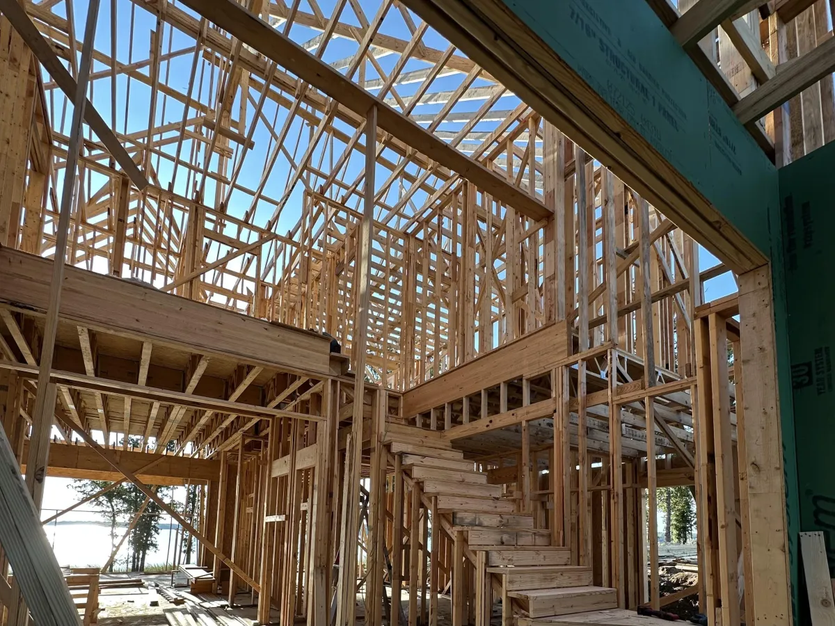 Precision residential framing work on a custom home before exterior finishes are installed
