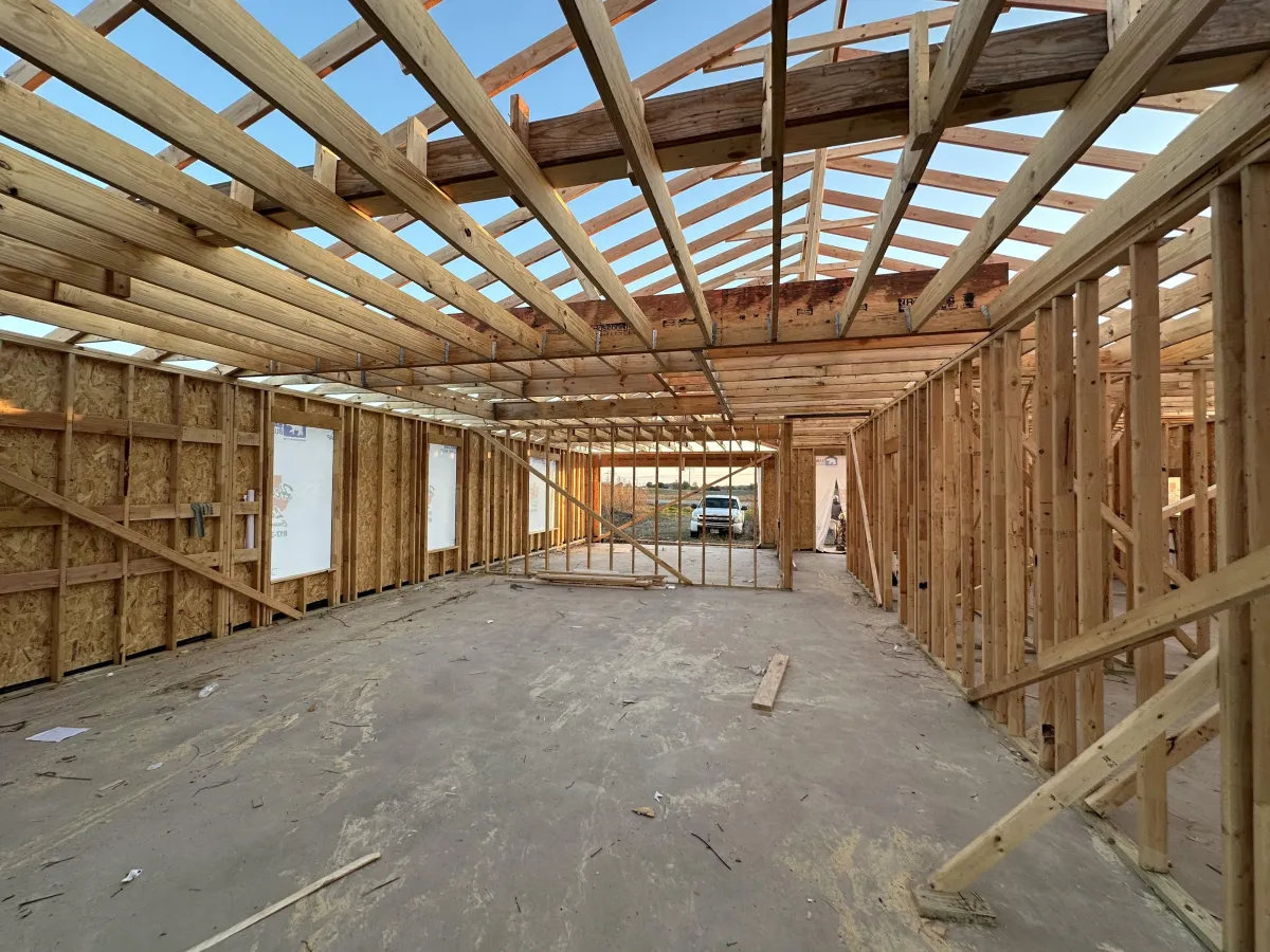 Precision residential framing work on a custom home before exterior finishes are installed