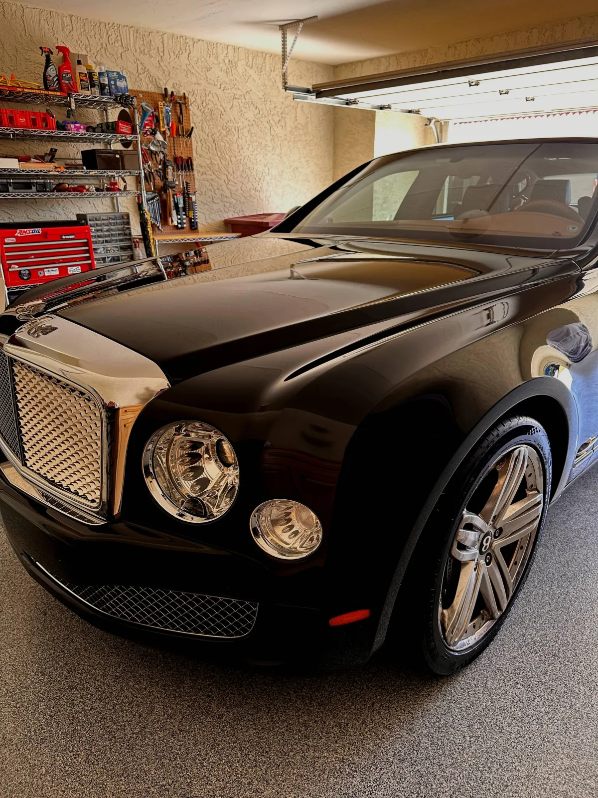 Clean and shiny Porsche leather steering wheel and red interior