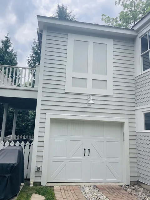 Victory Painting, LLC crew painting the exterior siding of a house in Easton.