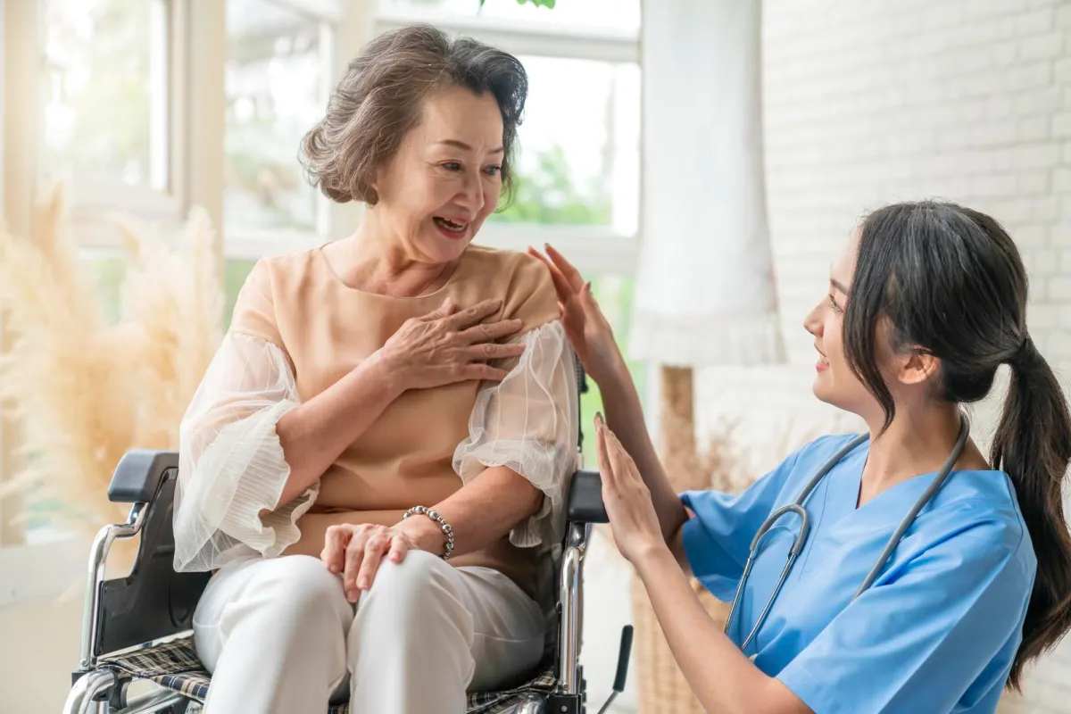 Nurse attending to their patient in their home, a house call visit.