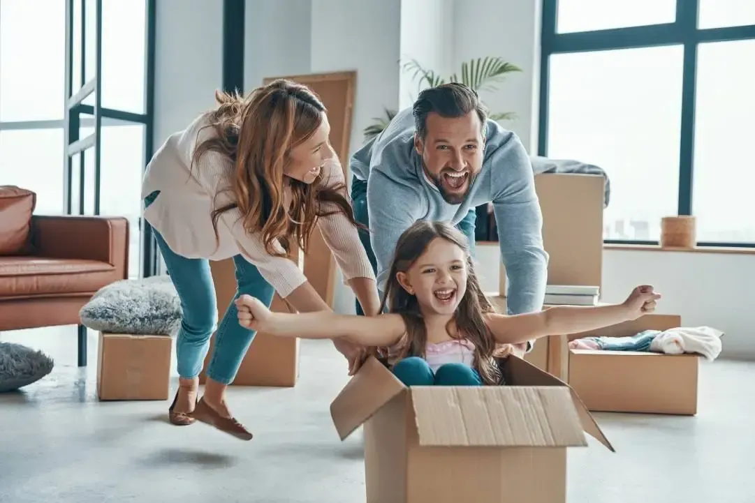 Family moving into the house, parents and daughter playing
