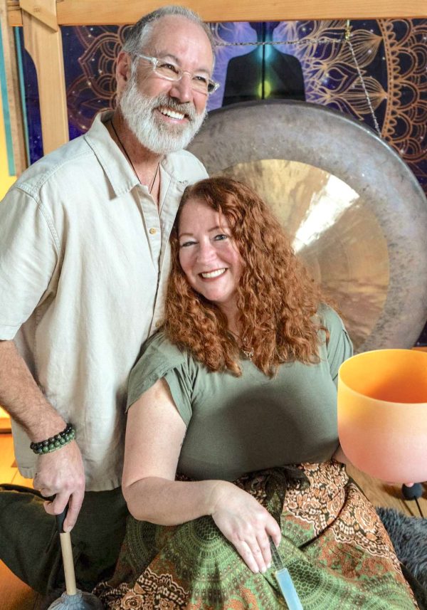 Our facilitators seated in the center of a sacred sound circle with instruments.