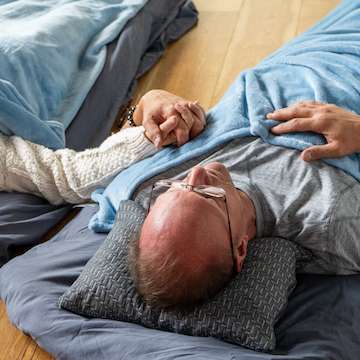 A couple holding hands during a sacred sound meditation session in Bend, Oregon.