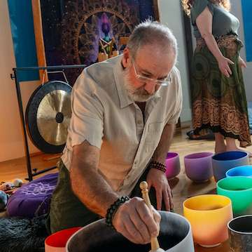 Kris playing crystal bowls during a sacred sound session at Hanai Foundation.