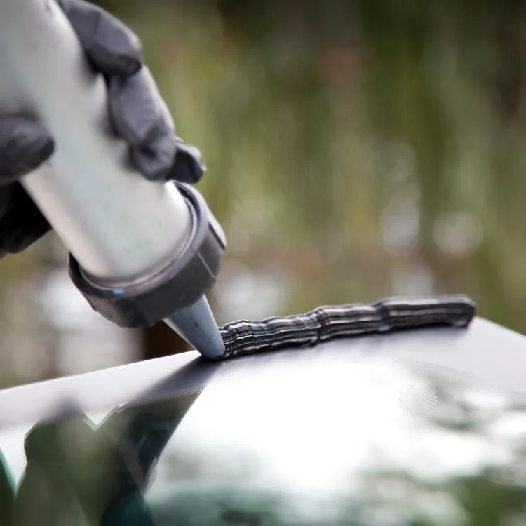 Tech applying ceramic coating to a car