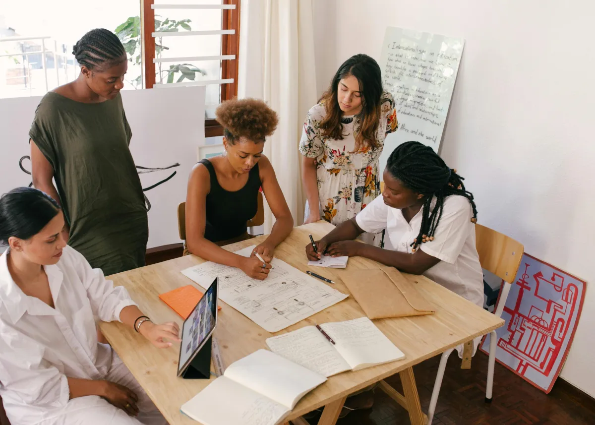 Business team meeting around a conference table discussing key person insurance benefits