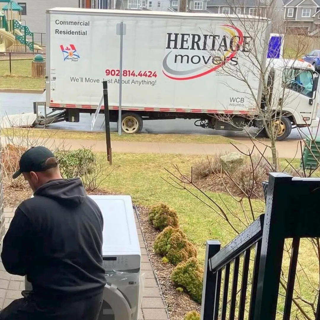 Heritage Movers professional carrying belongings into a new home, ensuring a smooth and stress-free move for families and seniors in Nova Scotia and the Maritimes.