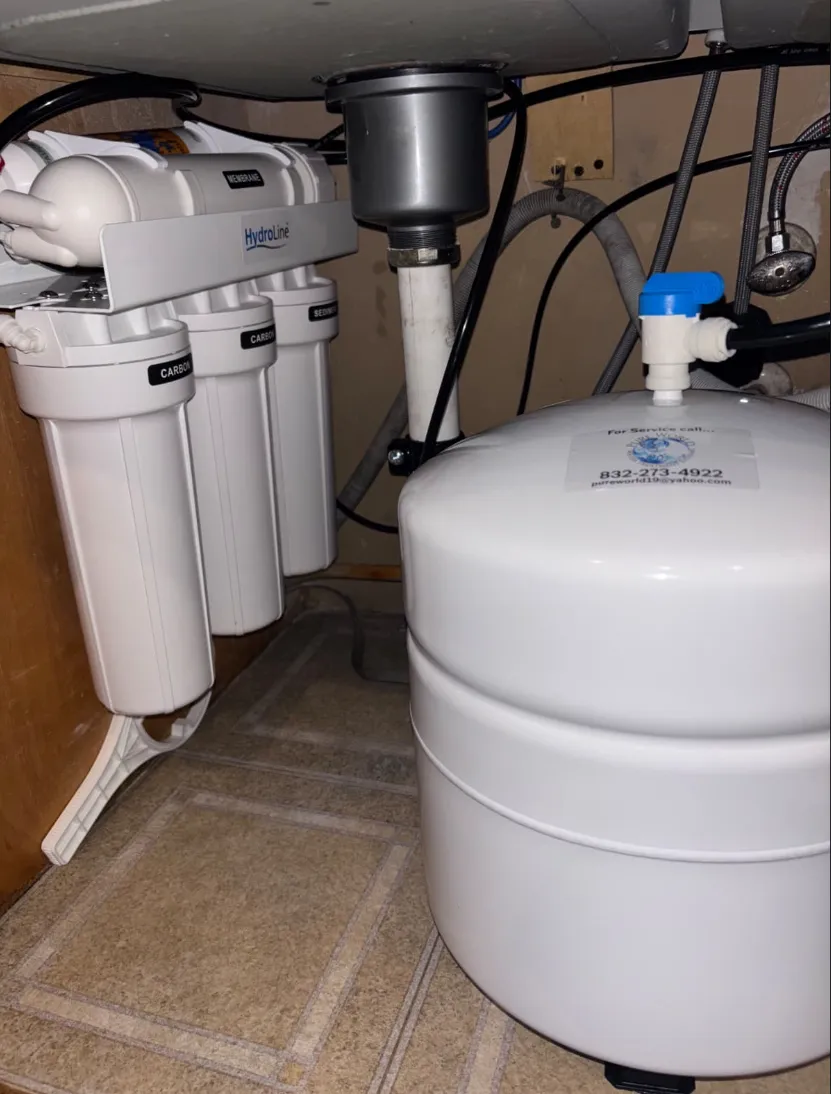 Covered outdoor kitchen with stainless appliances and lighting by Mundo Landscaping Tucson, AZ — custom backyard entertainment space.