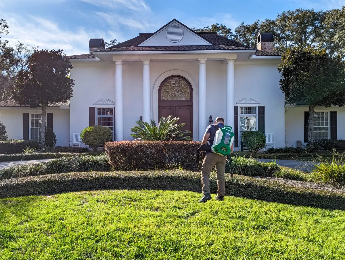Eco Lawn of Daytona technician carefully applying weed control to a property in Venetian Bay, FL.