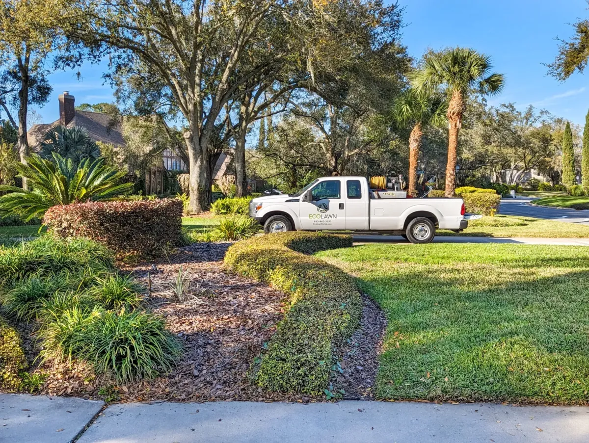 Eco Lawn Florida finishing a flowerbed weed control application in Daytona.