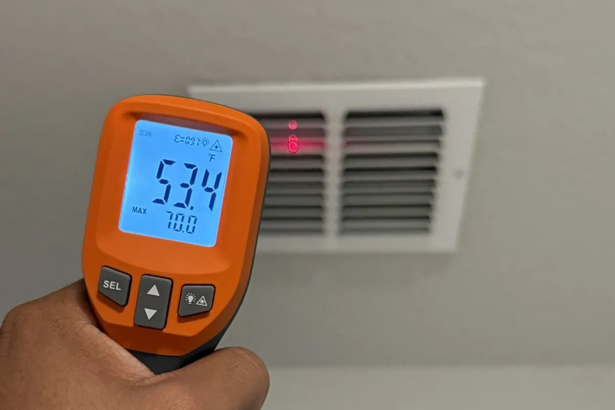 MTIS inspector checking AC vent temperature in a San Antonio rental