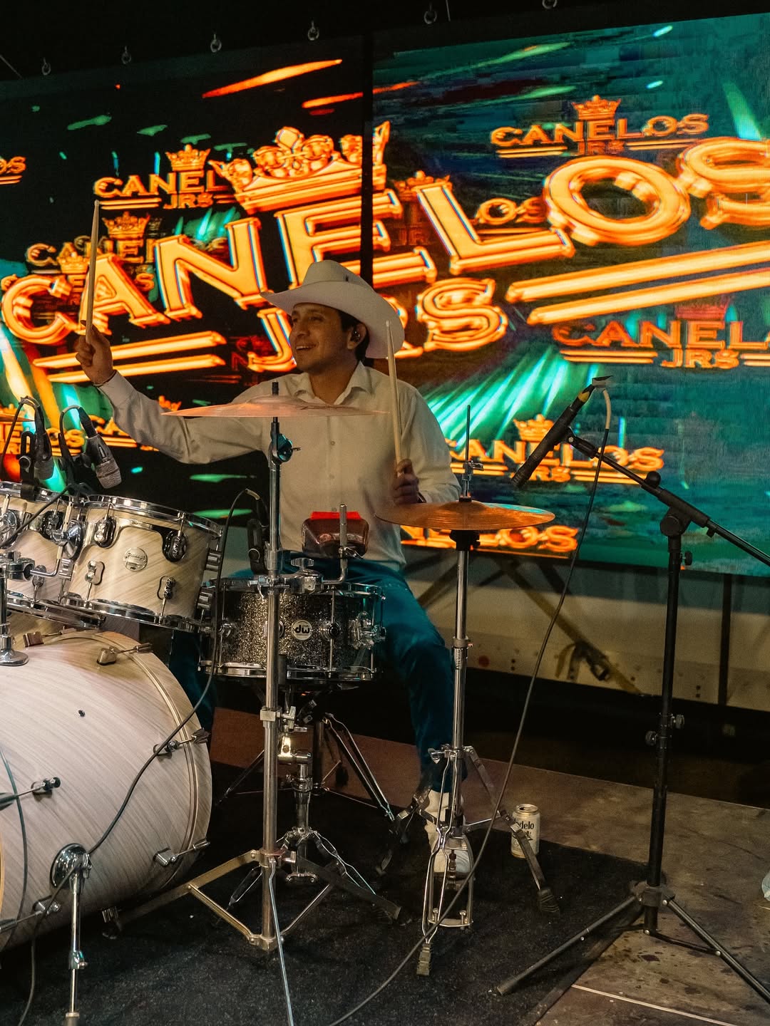 Latina headlining artist performing under stage lights, representing MMG’s artist booking capability.