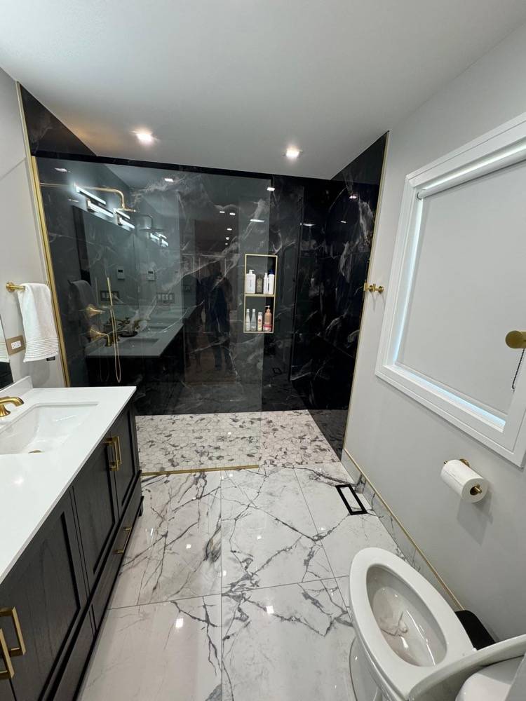 Luxury bathroom with black marble shower walls, white marble floor and dark vanity