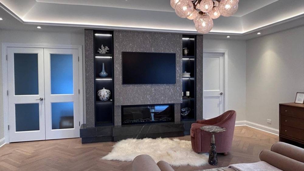 Living room with custom built-in entertainment center, linear fireplace and herringbone flooring