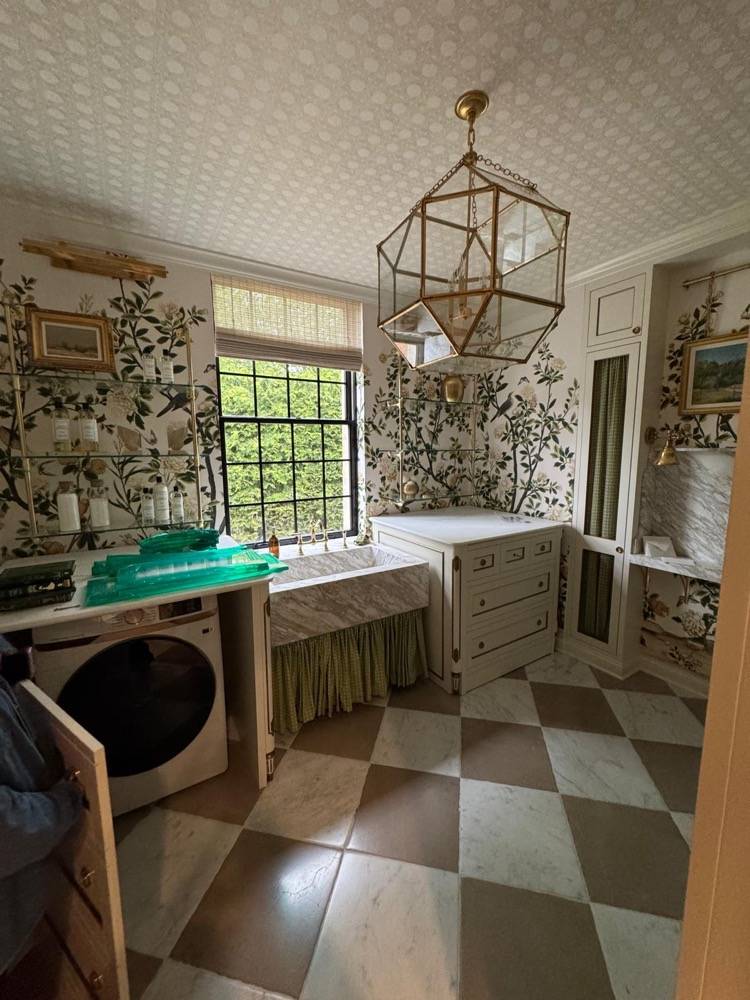 Laundry room renovation with botanical wallpaper, checkered tile floor and geometric pendant light