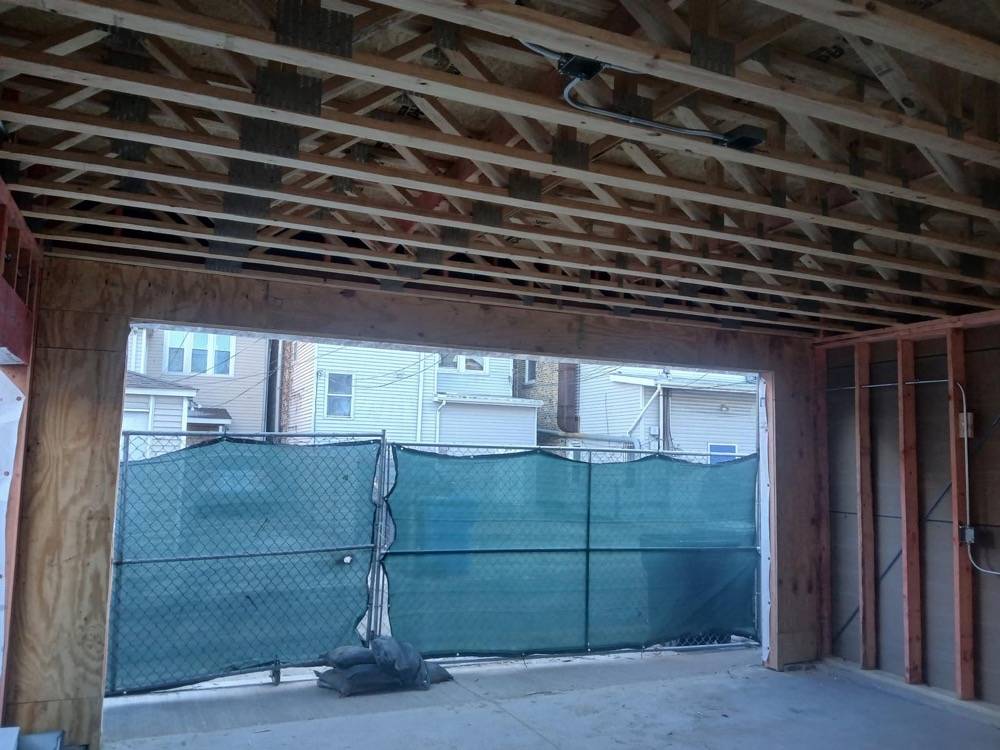 New construction framing showing exposed roof trusses and wall studs