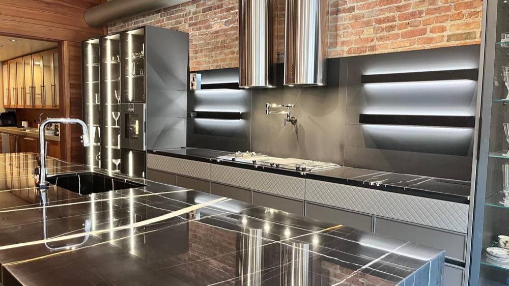 Industrial kitchen with stainless steel countertops and exposed brick walls
