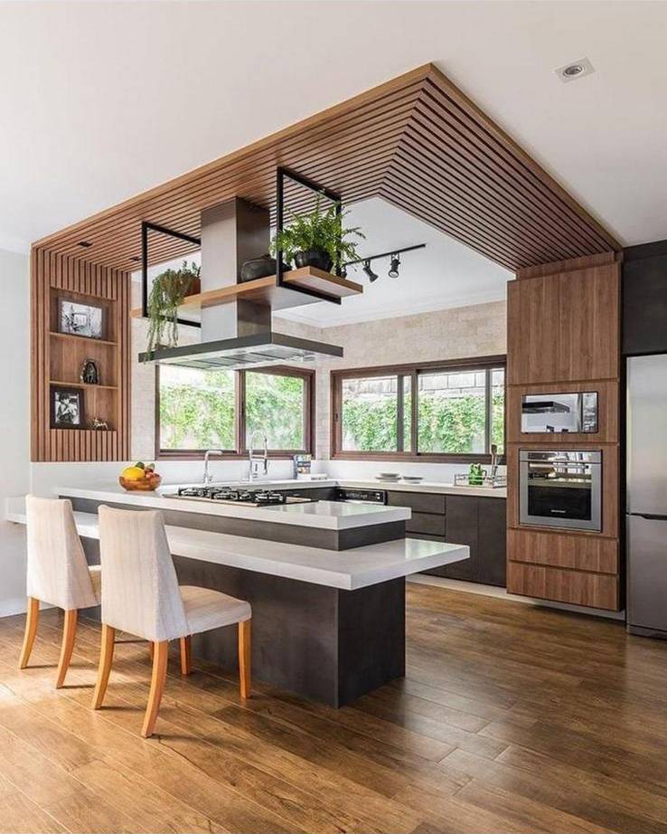 Contemporary kitchen with walnut cabinetry, slatted wood ceiling feature and island seating
