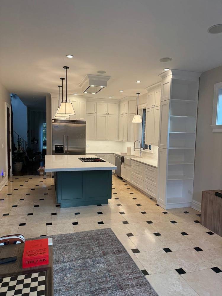 Kitchen remodel with white cabinetry, teal island and black-and-white diamond tile floor
