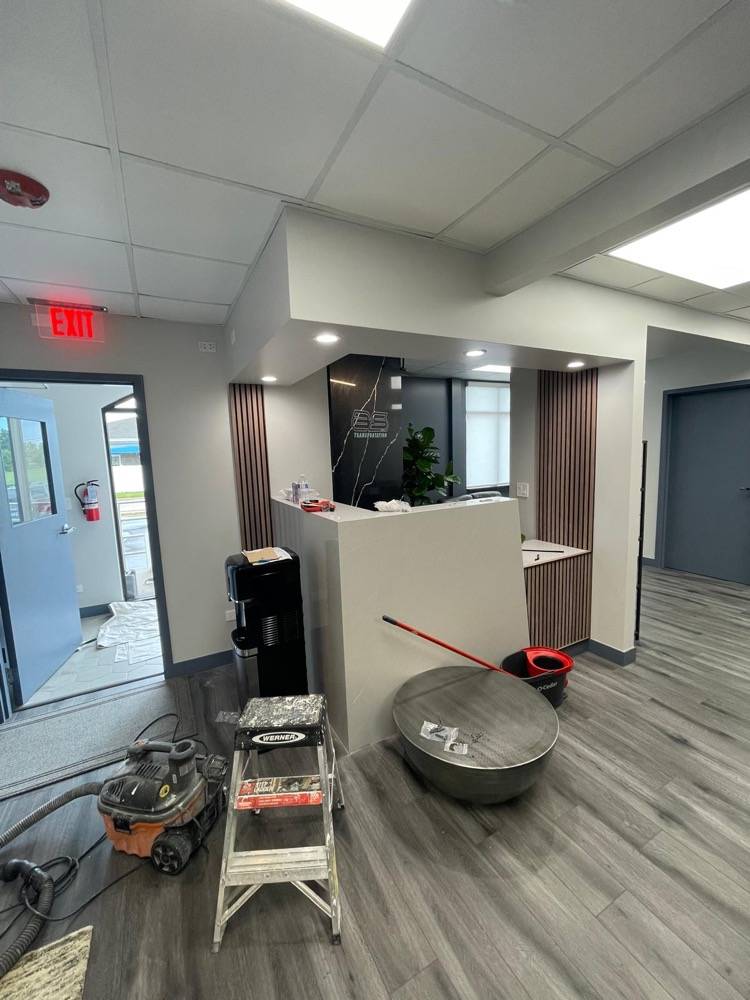 Commercial reception area renovation with new front desk and flooring