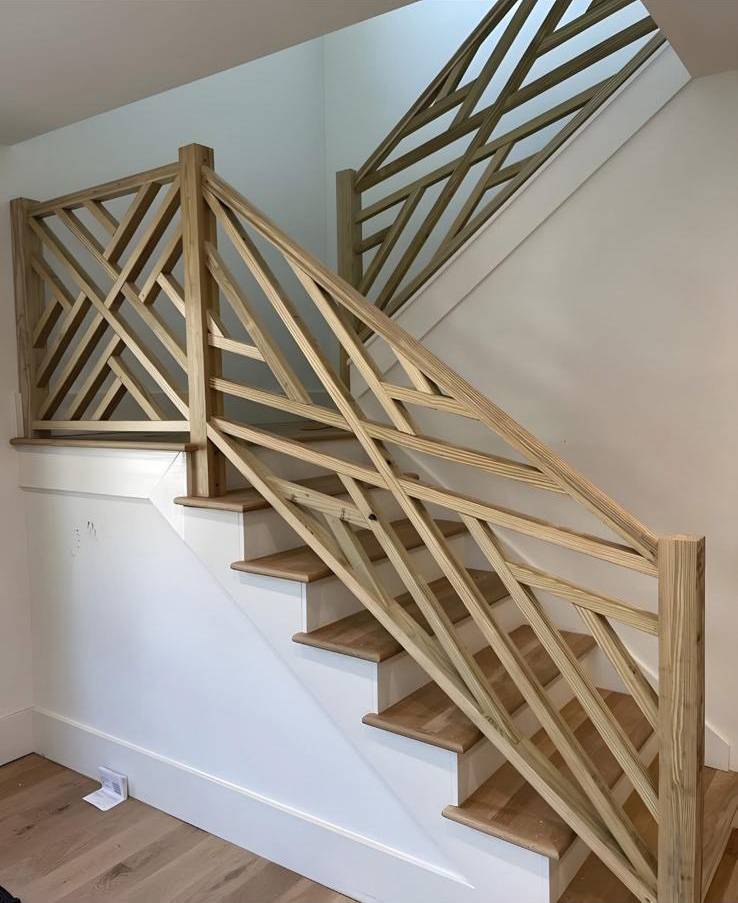 Custom geometric wood staircase railing with contemporary crosshatch pattern