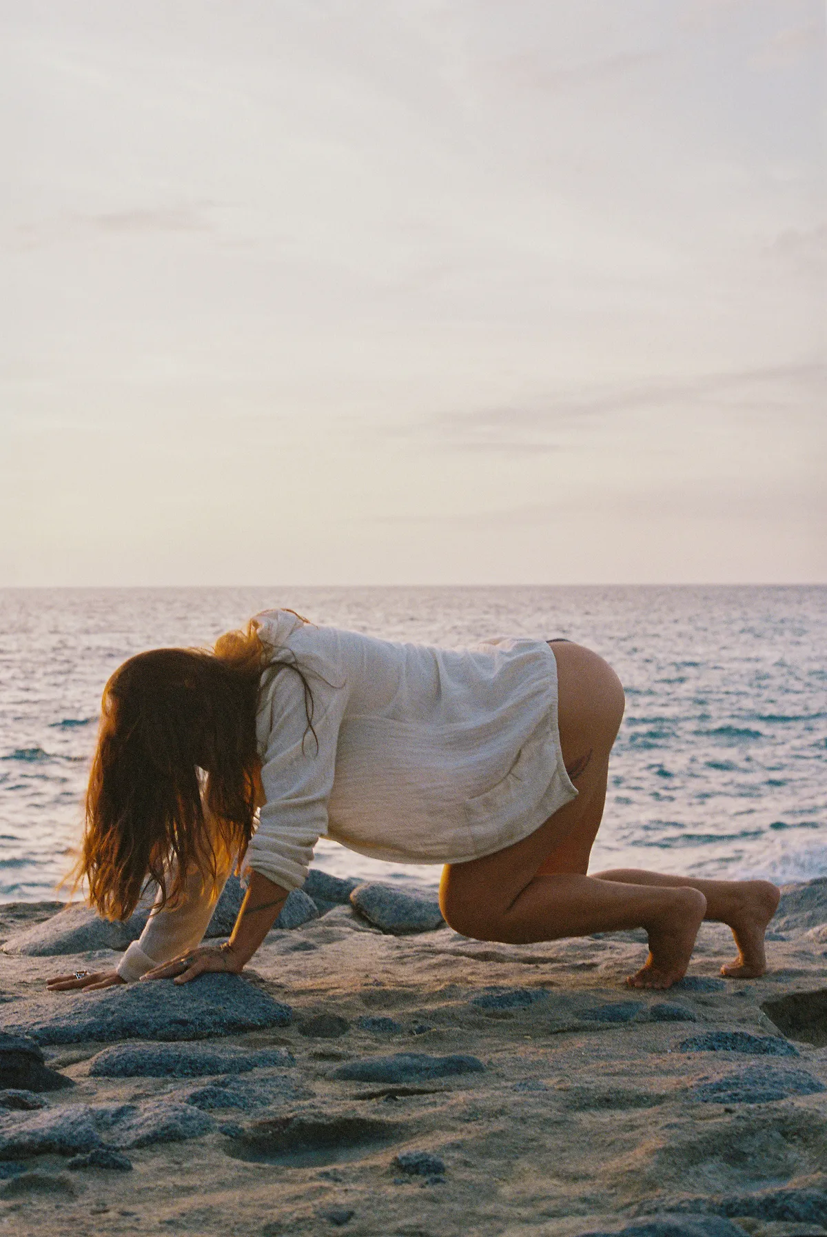 Amalia moving slowly on the rocks by the sea