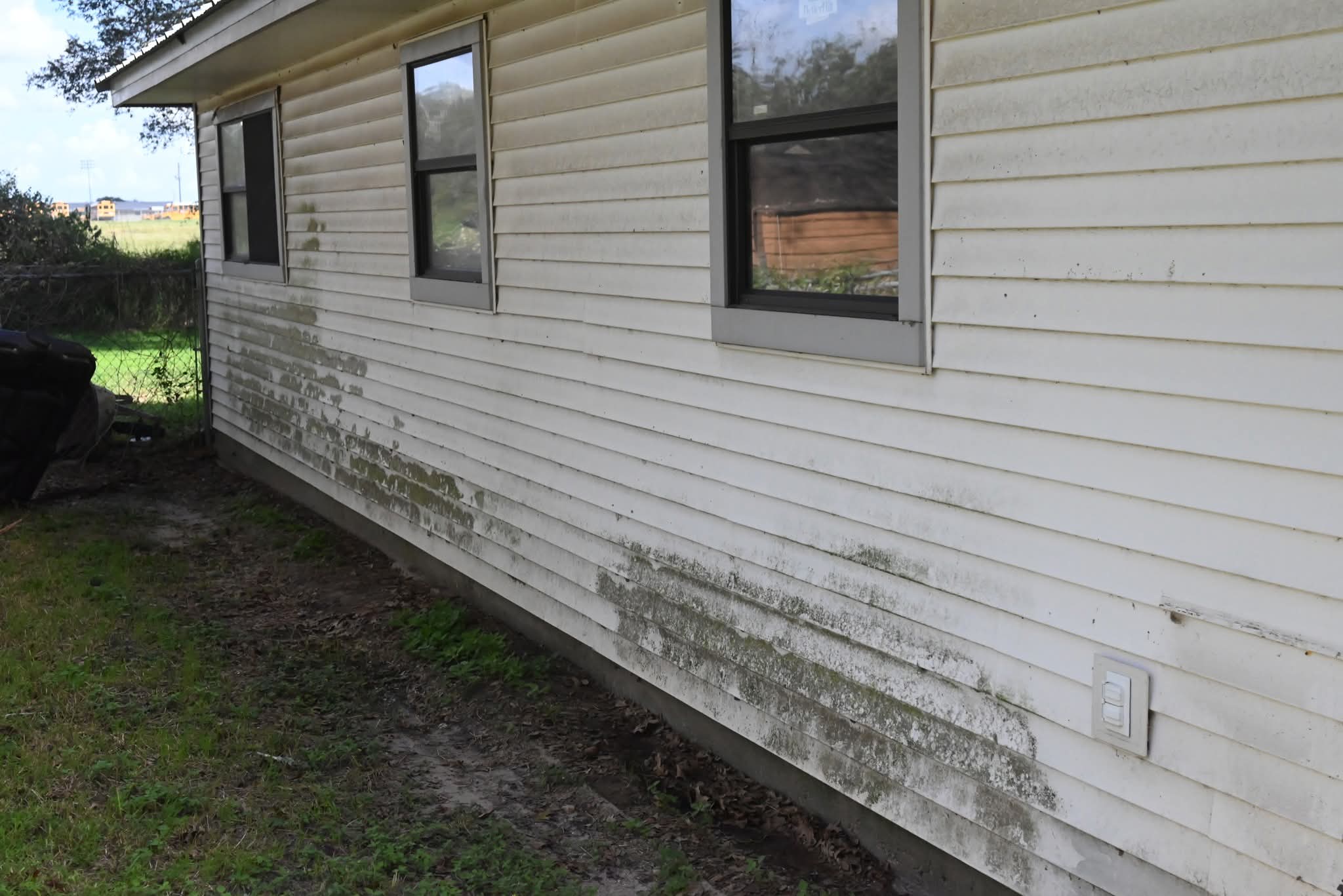 Before Maddux Pro Wash house siding in Goliad County