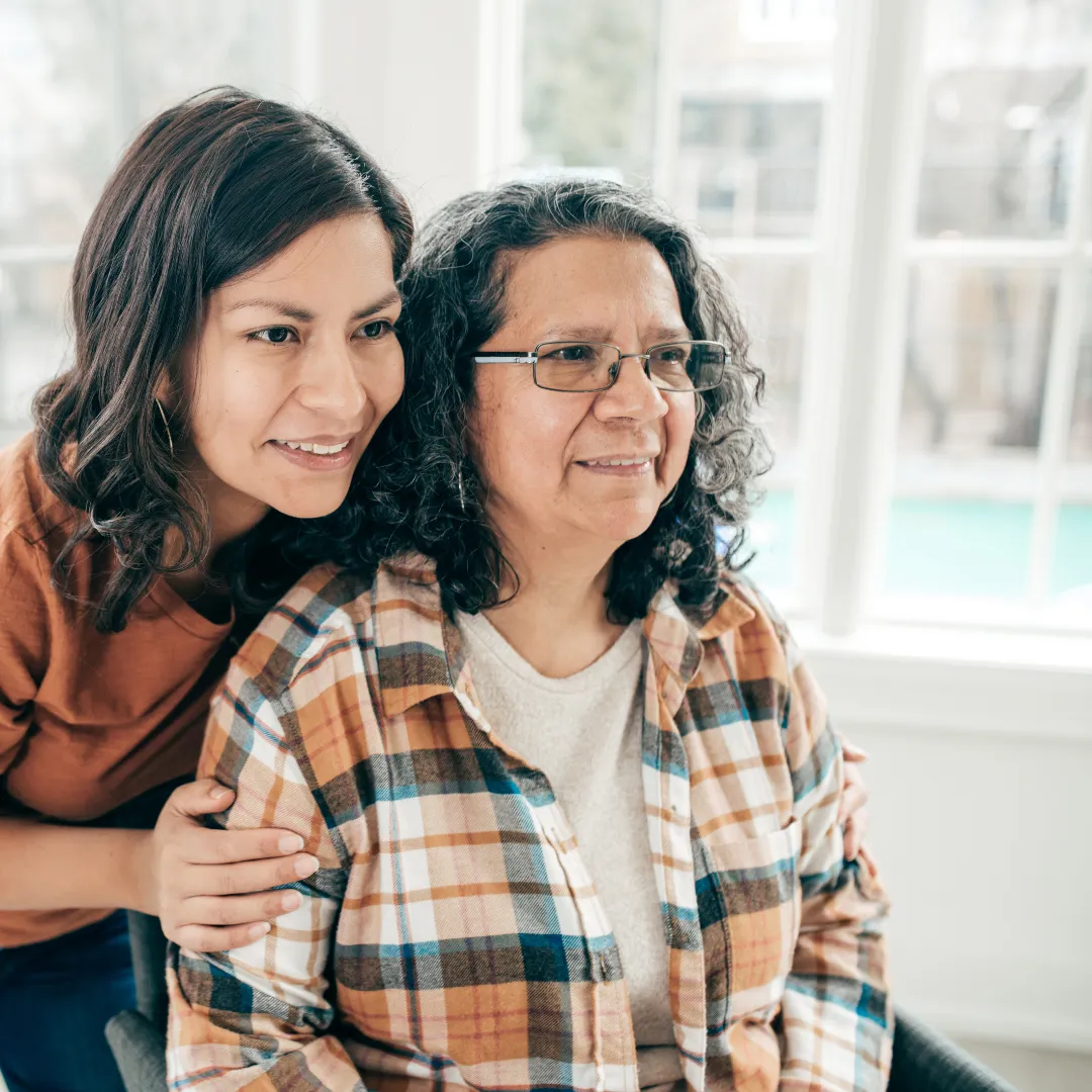 Woman looking over older womans shoulder