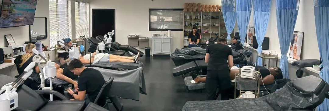 Forest City Student performing facial treatment during skin care program in Apopka at Hyphen Beauty School